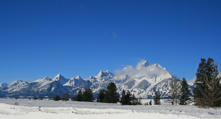 Snow mist blowing over Grand Tetons Mountain Range