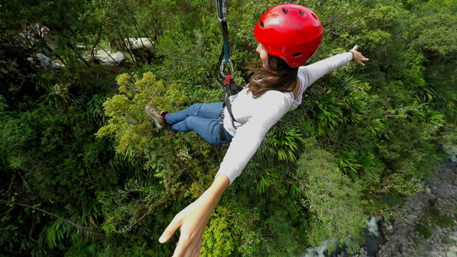 Experience the thrill of beautiful young women sliding on a zipline as the camera gracefully rotates around,capturing every exhilarating moment.