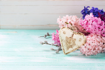 Hyacinths  and  decorative heart  on  turquoise  wooden backgrou