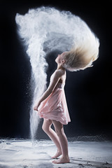 Naklejka premium Portrait of dancer flipping hair with white powder