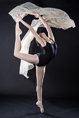 Portrait of young ballet dancer with flying lace