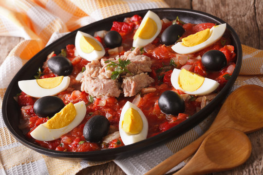 Arabic Mechouia salad with vegetables, tuna and eggs close-up
