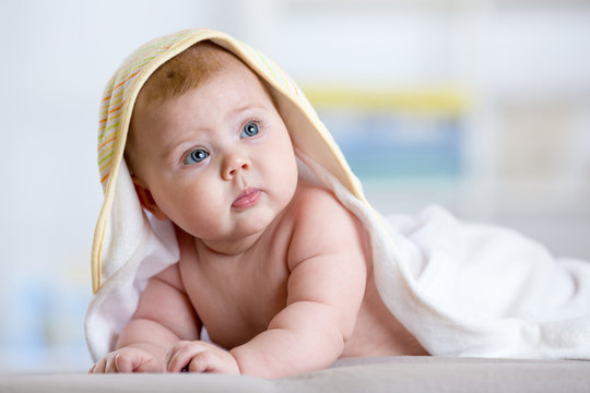 Baby after shower or bath with towel on head
