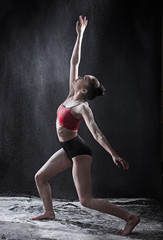 Fototapeta premium Dramatic portrait of strong teenage dancer with white powder exp