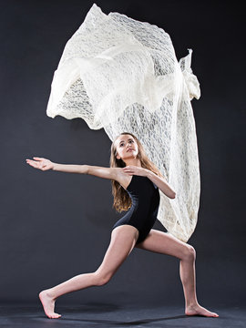 Portrait of young ballet dancer with flying lace