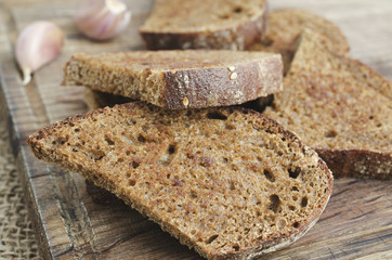 Toasted rye bread on a wooden board. Rustic style.