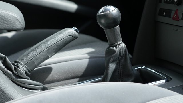 Car manual transmission and hand brake stick shift slow tilt 4K 3840X2160 UltraHD footage - Manual gearbox shifter and seats in modern car tilt 4K 2160p UHD video 