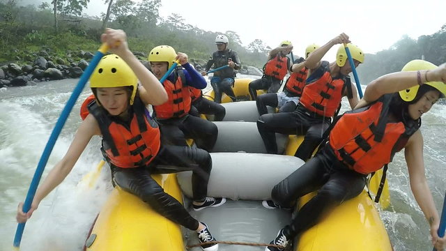 Both Asian Girls Leading Whitewater Rafting Boat Slow Motion Converted From 120fps Footage Run Building Sport Tourist Rafting Water White Team Two Flow Teamwork Group Boat Industry Helmet Travel Whit