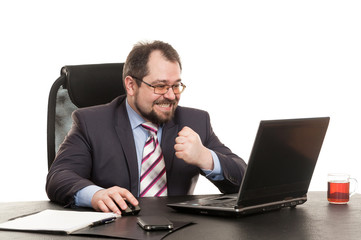 the businessman sits at office table