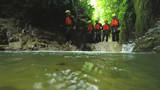Experience the breathtaking beauty of Llanganates National Park as a group of tourists leisurely explores the Ecuadorian canyon in stunning slow motion footage captured from water level.