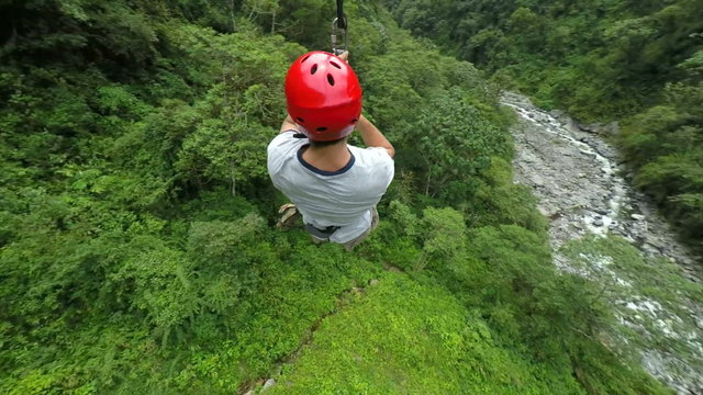 Experience the thrill of adult men riding a zipline captured through high quality camera footage,providing an exhilarating adventure for all.