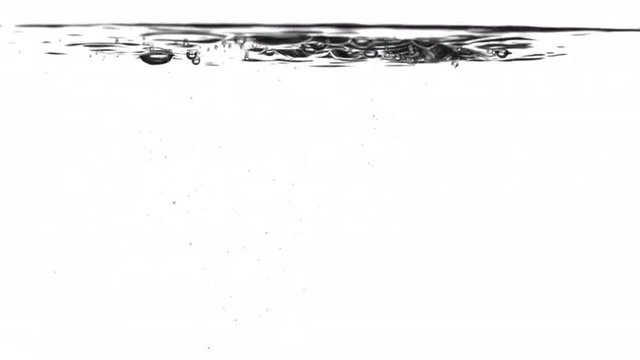Pouring water splashes and creates bubbles underwater. Locked off with white background, originally recorded in 4K.
