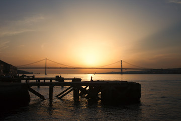 Fototapeta na wymiar Sunset at Almada Quay and 25 de Abril Bridge in Lisbon