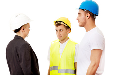 Female engineer talking with two builders