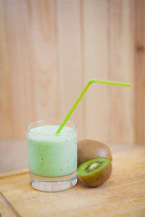 Summer cocktail of kiwi fruit and ice cream on a wooden background