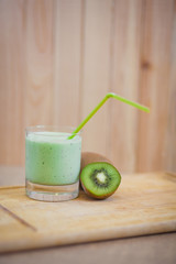 Summer cocktail of kiwi fruit and ice cream on a wooden background