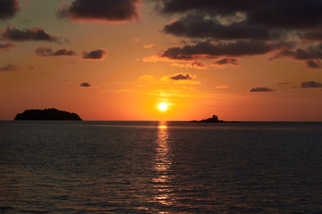 Sunset in Thailand, Koh Chang island. Orange sun and ocean.