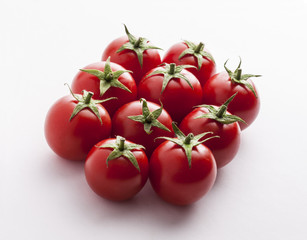 Tomatoes overhead group lined up close up on white background in studio 