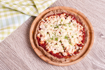 Colorful pizza with cheese, chicken and dill close up top view.