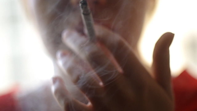A girl smokes sigarette