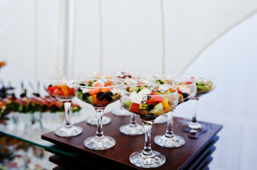 Glasses with Greek salad on reception