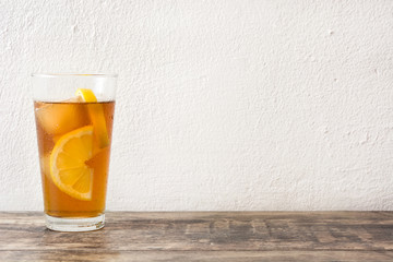 refreshing iced tea with lemon on wood