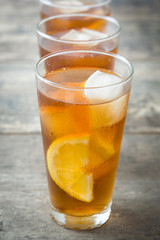 refreshing iced tea with lemon on wood