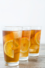 refreshing iced tea with lemon on wood