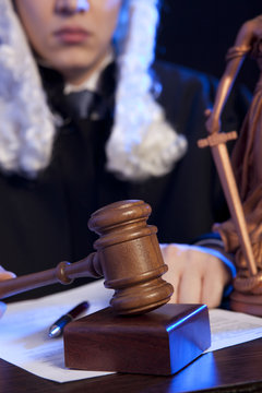 Male judge in a courtroom striking the gavel