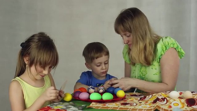 Preparation of Easter eggs, the feast of the passover, sticking decorative stickers on the Easter eggs
