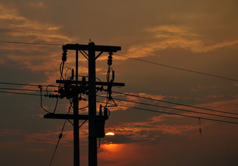 high voltage electric pole on sunset