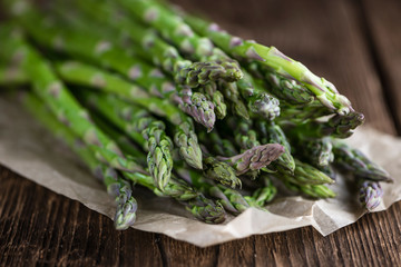 Green Asparagus (close-up shot) on wood