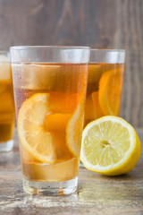 refreshing iced tea with lemon on wood