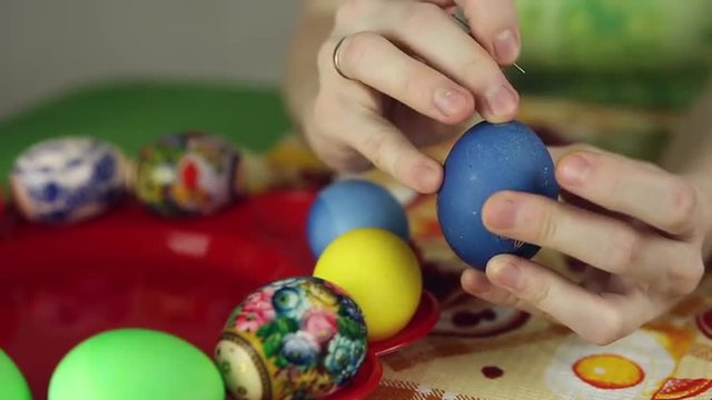 Preparation of Easter eggs, the feast of the passover, girl sticks decorative stickers on the Easter eggs
