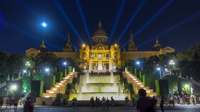 Famous light show and magic fountains timelapse hyperlapse in front of the National Art Museum at Placa Espanya in Barcelona at night, Catalonia, Spain