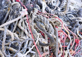Tangled, old ropes. Stack of old, weathered ropes with selective focus. Close-up of nautical vessel. Chaos scene.