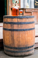 Wine in old bottle on a barrel.