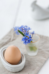 Easter decoration with violet flowers and egg