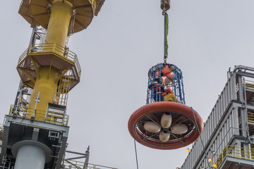 Personal transfer basket. Offshore crew being transferred from oil rig to the boat using personal...