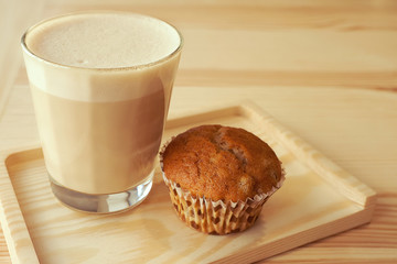 Cup of cappuccino and muffin; selective focus