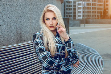 Portrait of pretty blonde business woman with blue eyes talking