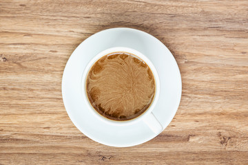 top view of coffee white cup on wooden background