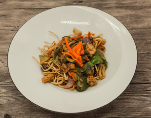 The Chinese fried noodles with squids, an octopus and vegetables.