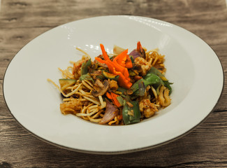 The Chinese fried noodles with squids, an octopus and vegetables.
