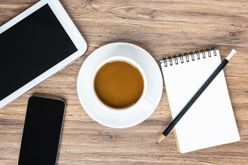 View from above of coffee cup with black smartphone, digital tab