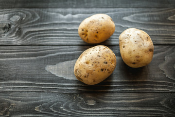 Fototapeta na wymiar potatoes on wooden rustic background