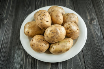 potatoes on wooden rustic background