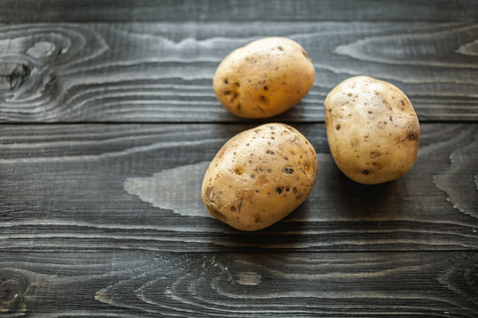 potatoes on wooden rustic background