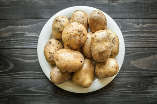 potatoes on wooden rustic background