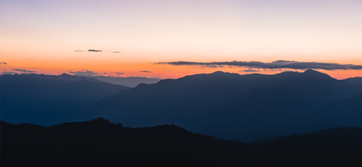 Sunset over black mountains in the fog, Mountain layer background
